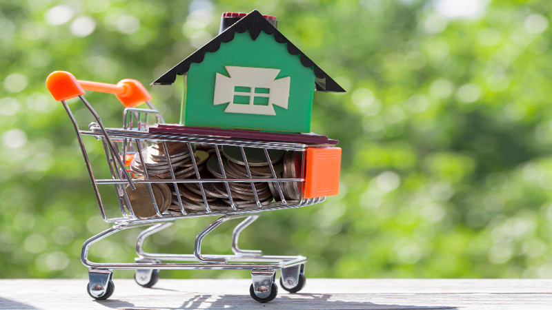 A model house figure on a card in blurred background