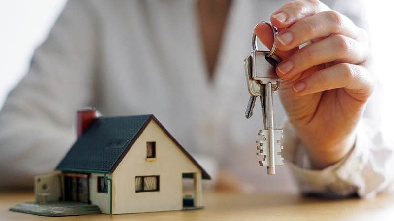 Image of a person holding a house key