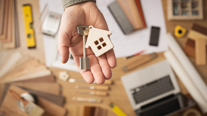 A real estate agent with a key to a house sold from off market