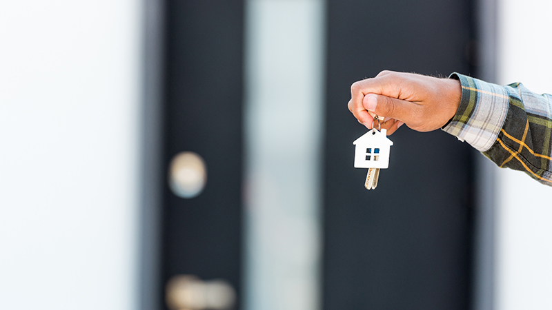 Image of hand holding house keys focused